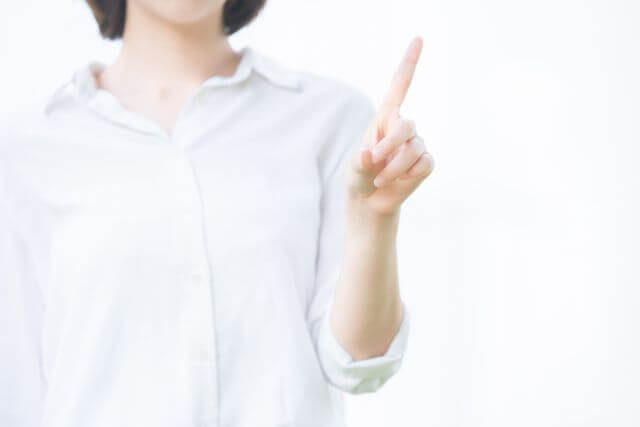 人差し指を立てる女性